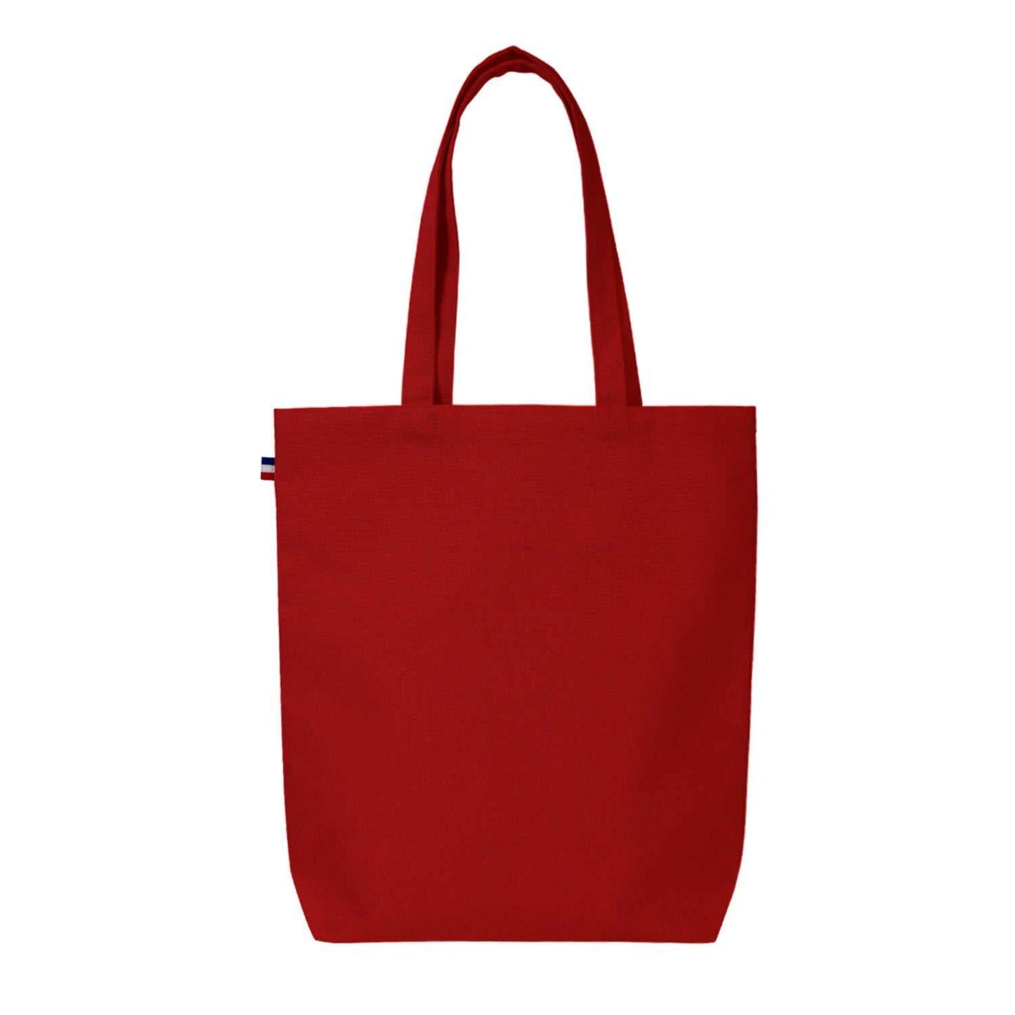 Sac cabas en coton beige avec soufflet de fond, fabriqué en France, posé sur une table en bois avec accessoires de mode